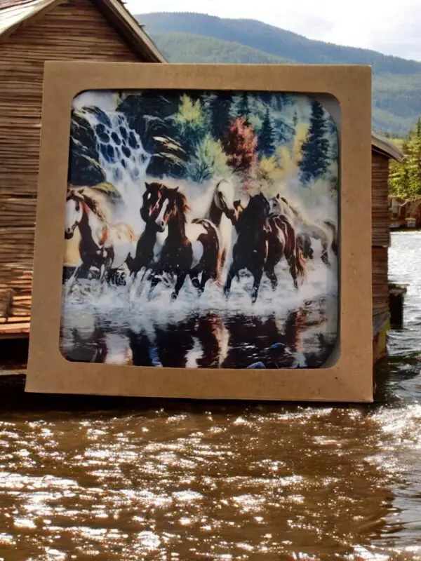 Horses Running In Water Surrounded By Trees